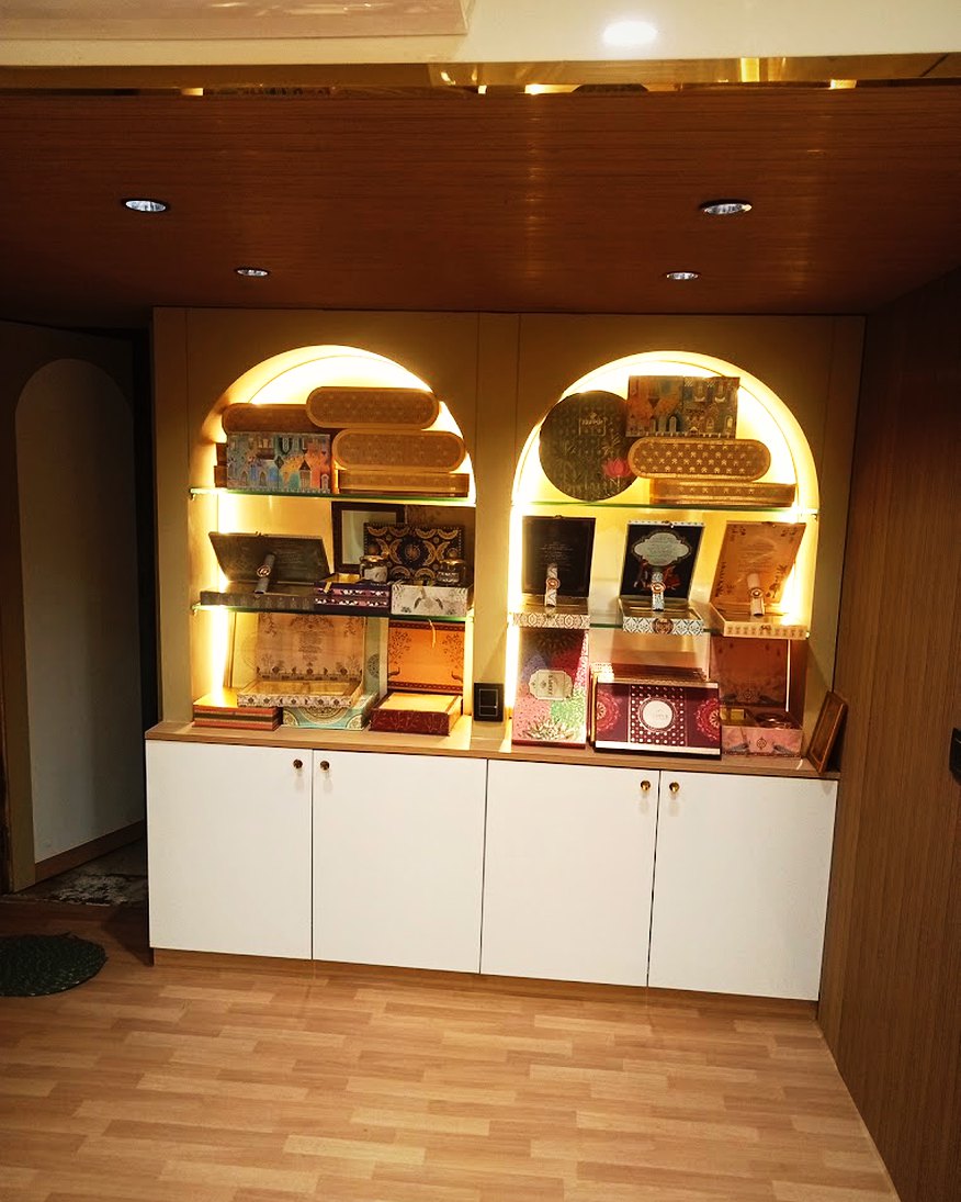 Lit arched alcoves holding sweet boxes along the shop wall
